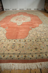 Vintage Tabriz carpet's lush pile, detailed border, and terra cotta field seen from an angled perspective.