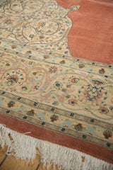 Ornately scrolled corner spandrel and border of a vintage Tabriz rug with clean fringe.