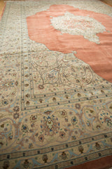 Angled view of the vintage Tabriz rug's intricate ivory corner spandrel and ornate floral border.