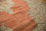 The plush, even wool pile of the vintage Tabriz rug's open terra cotta field.