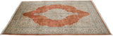 Angled view of the vintage Tabriz carpet, displaying the large terra cotta field and central starburst medallion.