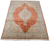 Full perspective of a vintage Tabriz carpet, highlighting its grand scalloped medallion and terra cotta field.