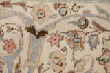 Fine floral and arabesque details in slate blue and rust on a plush, ivory hand-knotted carpet.