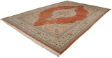 Angled view of a vintage Tabriz carpet with a central starburst medallion on a terracotta field.