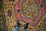 Vintage Ardebil carpet with ochre field, blush medallion, geometric finned birds and plants.