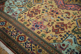 Vintage Ardebil carpet with geometric birds, animals, and plants in blush, mint, ochre.
