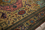 Geometric finned birds and plants on ochre Ardebil carpet field with green patterned border.