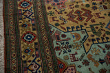 Vintage Ardebil carpet's ivory fringe and geometric green border with playful ochre motifs.