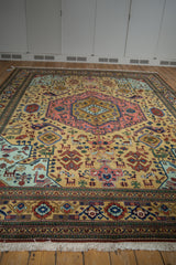 Intact fringe and geometric animal motifs on a vintage Ardebil carpet.