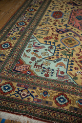 Vintage Ardebil rug's mint green panel with playful geometric finned animals and plants.