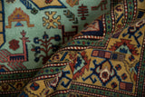 Geometric finned birds and plants on mint green and ochre fields of vintage Ardebil rug.
