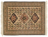 Vintage Persian Ardebil rug with three diamond medallions in navy and blush over a sand colored field.