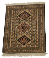 Angled view of a vintage Persian Ardebil rug showing its triple diamond medallions and detailed field.