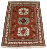 Angled perspective of the vintage Meshkin carpet highlighting its triple medallion design and bird motif border.