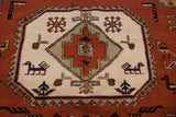 A geometric medallion with stylized birds and floral motifs in rust, navy, and ivory.