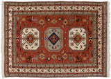 Playful geometric birds and animal motifs on the rust field of a vintage hand-knotted Meshkin carpet.