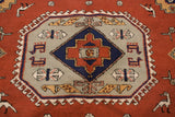Geometric medallion detail with stylized birds and a hook-latch border on a vintage Meshkin carpet.