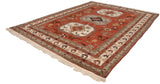 Vintage Persian Meshkin carpet from an angle, showing the triple geometric medallions on a rust field.