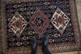 A personal view of the vintage Ardebil rug, showing the scale of its triple diamond medallions.