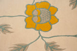 Arts and Crafts style saffron yellow flower, ocean blue vines, and silver leaves.