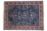 Hand-knotted 9x12 Vintage Laristan carpet in dusty denim blue with cherry red borders and allover millefleur.