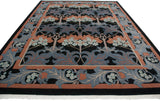 Angled view of vintage William Morris arts and crafts rug, black, blue, and terracotta floral pattern.