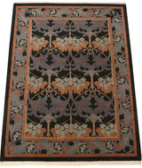 Arts and Crafts William Morris carpet corner with scrolling gray leaves, blue blossoms, and terracotta border.