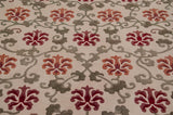 Plush sculpted pile of a vintage Arts and Crafts carpet with red and terra cotta lotus flowers.