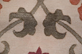 Macro detail of the full, hand-knotted pile showing oxidized silver scrolling vinery.