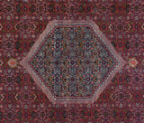 Slate blue Herati medallion edge with dusty raspberry red field on a vintage Bijar rug.