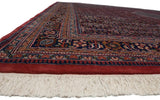 Ivory fringe and richly patterned dusty raspberry red and navy blue border.