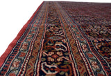 Vintage Indian Bijar rug border, showing dusty raspberry red selvage and intricate navy, gold patterns.