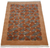 Vintage Art Deco rug with playful geometric triangles and squares in terracotta and silver.