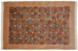 Art Deco Indian rug with terracotta, silver geometric pattern and beige squares, visible fringe.