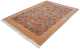 Indian Art Deco rug corner, terracotta and grey geometric pattern, beige border, white fringe.