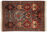 Vintage Agra rug with an asymmetric layout of oversized florals in dusty blue, wine red, and beige.