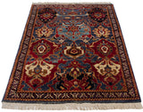 Angled perspective of a vintage Agra rug showing its oversized floral medallions and palmettes.