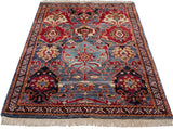 Angled view of a vintage Agra rug showing its staggered, asymmetric floral pattern.