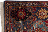 Corner detail of a hand knotted Agra rug showing the full pile, original selvage, and fringe.