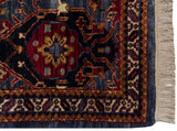 Corner of a vintage Agra rug showing the plush pile, intact side cord, and clean ivory fringe.