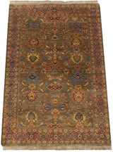 Vintage Agra carpet corner showing sage green field, ornate wine red and gold floral border.