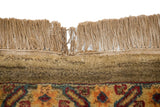 Tea washed vintage Agra carpet fringe detail showing a tear and floral patterns.