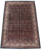 Angled perspective of a vintage Indian Bijar carpet with a dense floral pattern on a navy field.