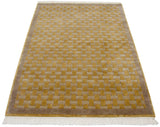 Hand woven vintage Indian rug with carved basket weave pattern in saffron, beige, and mauve.