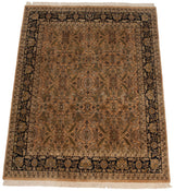 Angled view of a vintage Heriz carpet's copper field and intricate navy border.