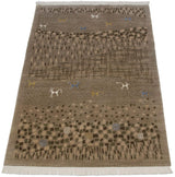 Angled view of an Indian folk art rug showing its pictorial landscape with animals.