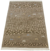 Angled view of an Indian folk art carpet with textural landscape and animal designs.