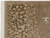 Corner of a folk art rug with rocky patterns, blue and ivory spirals, and a pictorial animal.