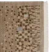 Art silk pinwheel spirals and rocky motifs on a folk art carpet with ivory fringe.