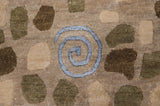 Close-up of a pale blue pinwheel spiral woven in art silk on a plush, hand-knotted pile.